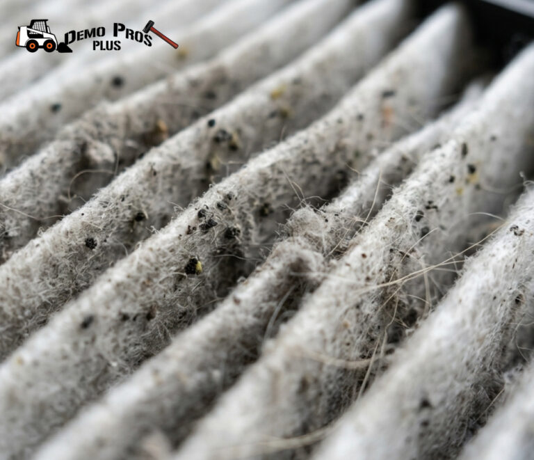 A person wearing blue nitrile gloves wiping a white countertop with a microfiber cloth and a spray bottle labeled soap solution